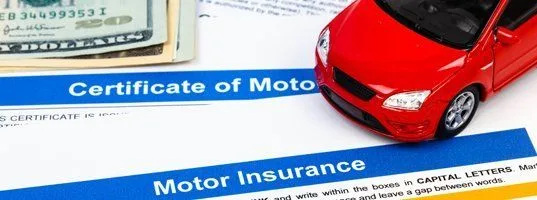 Motor insurance certificate with a toy car