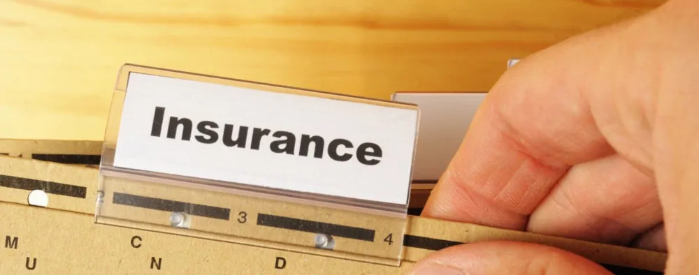 Hand pulling an insurance file folder