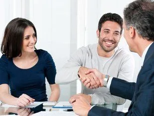 Agent shaking hands with clients